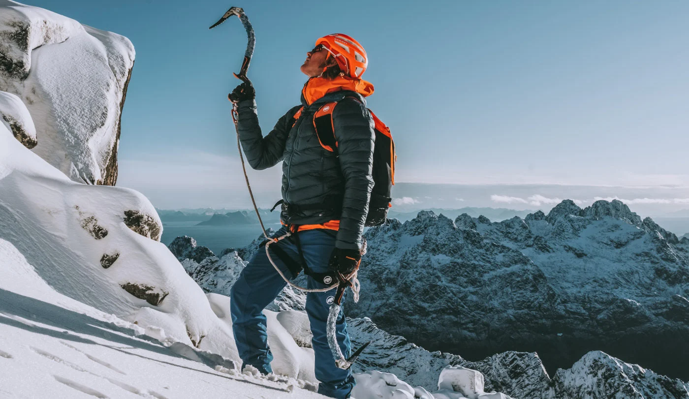 Mammut climber on a snow-covered mountain ridge